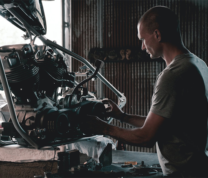 mechanic working on an engine in a garage